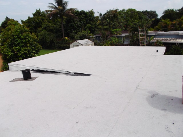 After photo of flat roof with white cap-sheet