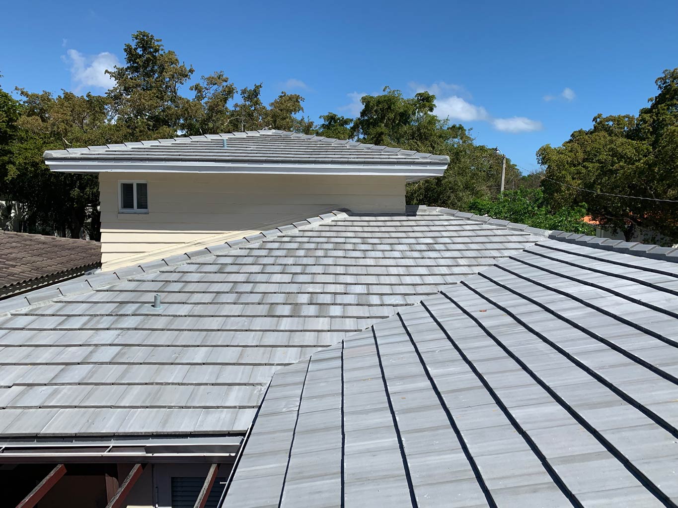 After photo of new gray concrete roof tiles installed at rear valley.