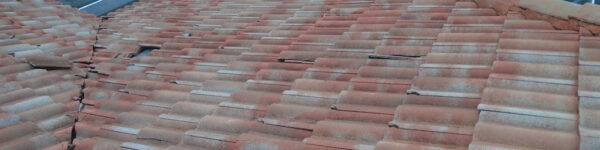 Existing roof with weathered and broken tiles